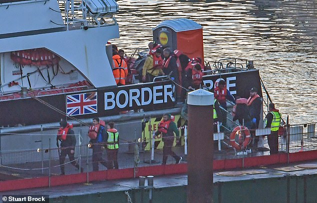 Border Force officers escort migrants to Dover Docks in Kent, United Kingdom on October 25, 2024