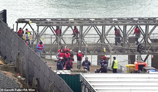 A group of people believed to be migrants are taken from a Border Force ship to Dover, Kent, following a small boat incident in the Channel on October 15, 2024