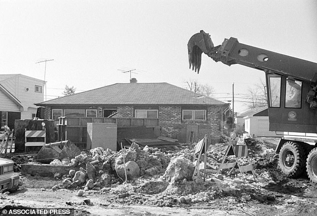 The serial killer was born in Chicago and was married to Marlynn Myers from 1964 to 1969, with whom he had two children. Pictured, excavators work outside John W. Gacy's home in suburban Chicago.