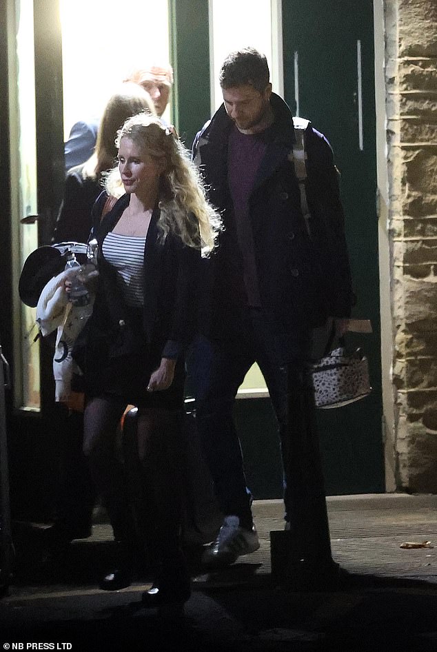 She cut a casual figure during the outing in a striped T-shirt and mini skirt which she paired with a long blazer and boots