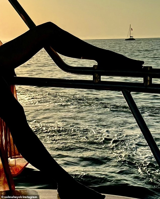 The From Dusk to Dawn star, 58, posed on the boat as the setting sun lit her up in the background