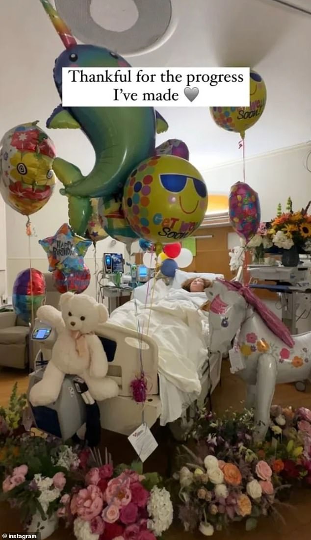 She also posted a sweet photo of herself surrounded by balloons and flowers in the hospital