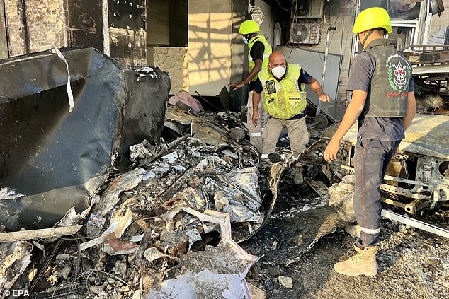 Search and rescue team members attempt to look for possible victims in a damaged building after an Israeli airstrike, in Tyre, Lebanon, October 28, 2024