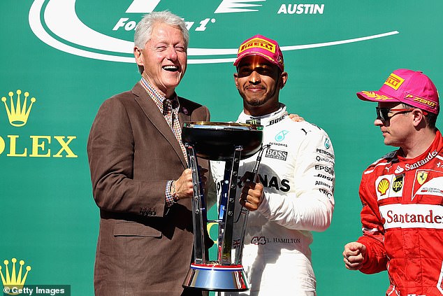 Former President Bill Clinton is pictured with Harris' favorite driver, Lewis Hamilton, in 2017