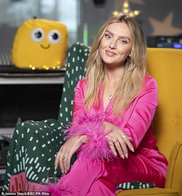 The 31-year-old singer cut a comfortable figure in the striking two-piece with a stylish feather trim as she took a seat in the iconic yellow armchair