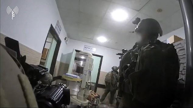 Israeli troops are seen sneaking through hospital corridors with weapons drawn