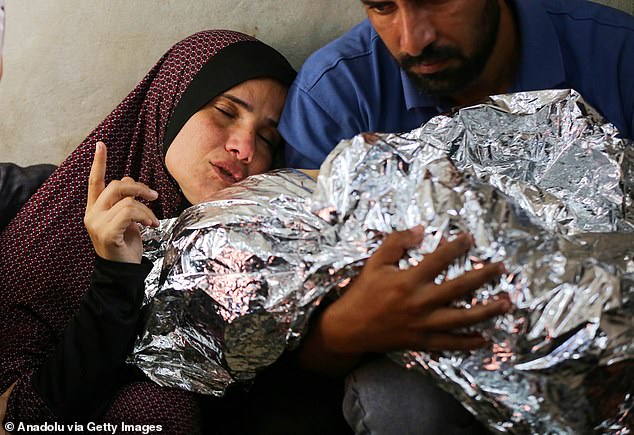 Palestinian child, who lost his life in a recent attack by the Israeli army on the Bureij refugee camp, the relatives of Mohammed al Dahdouh express their grief at Al Aqsa Martyrs Hospital in Deir al-Balah, Gaza on October 28, 2024