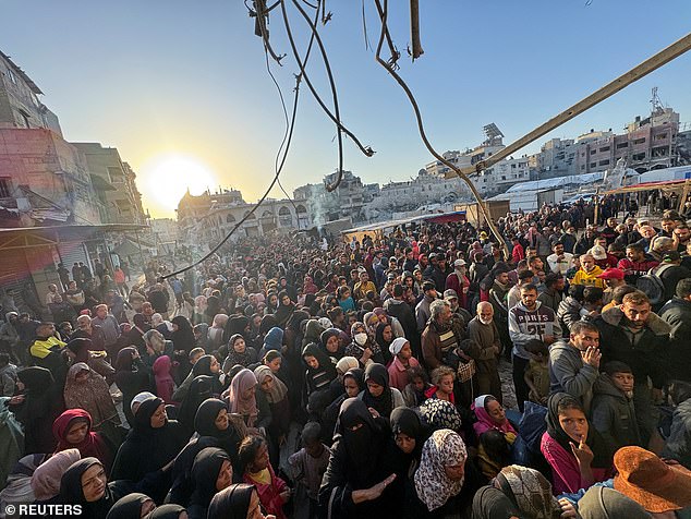 Palestinians gather to buy bread at a bakery, amid the conflict between Israel and Hamas, in Khan Younis, southern Gaza Strip, October 28, 2024