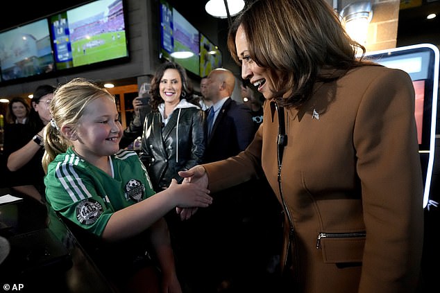 Harris also greeted people in the bar, like this young girl above