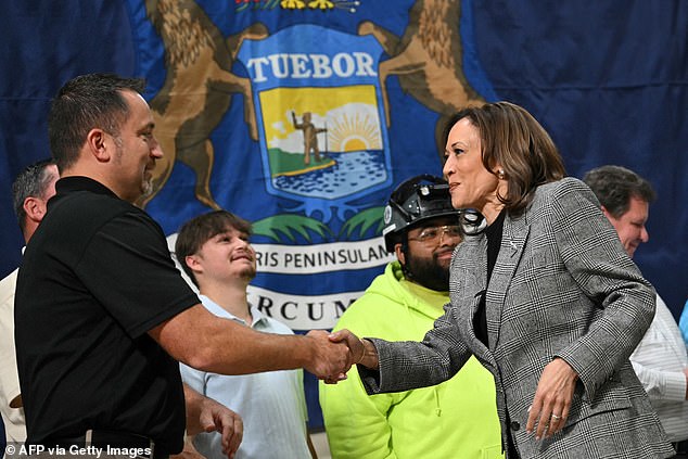 U.S. Vice President and Democratic presidential candidate Kamala Harris greets union workers as she visits an International Union of Painters and Allied Trades training facility in Macomb, Michigan on October 28, 2024