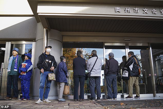 Fans in Oshu, Japan, line up to watch a stream of the match, with all eyes on Shohei Ohtani