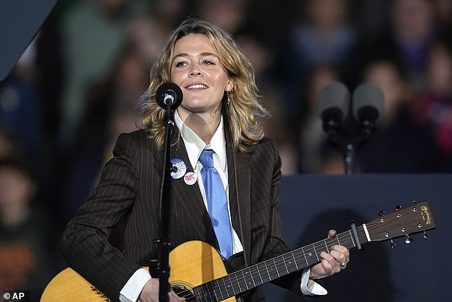 Rogers performed several songs at the meeting, including “Light On.” She also wore a Harris-Walz pin and a blue tie