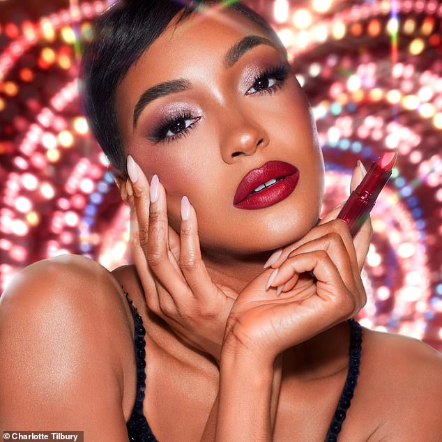 Jourdan Dunn oozed glamor as she painted her signature pout with bright red lipstick