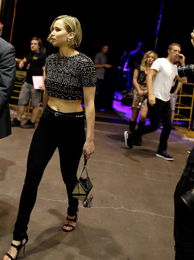 Jennifer and Chris (background) at the iHeartRadio Musical Festival in September 2014