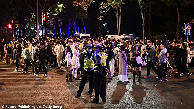 Last year, partygoers gathered on the street, where police were also present. Pictured: Citizens and tourists dress up and take part in a Halloween parade in Shanghai, China, October 31, 2023