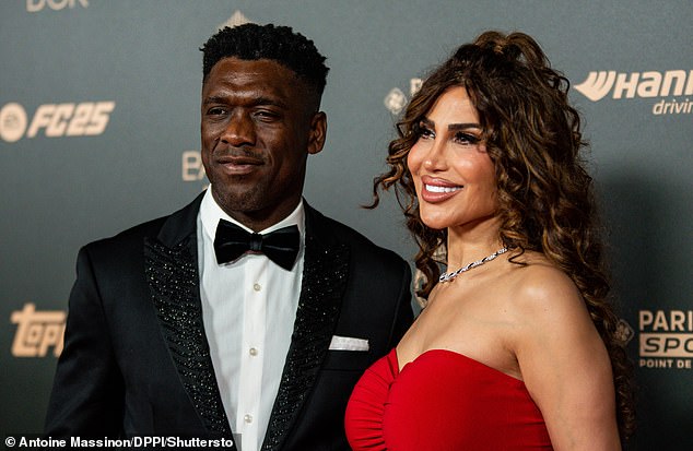 Clarence Seedorf (pictured with wife Sophia Makramati) believes Vinicius Jnr did not win due to 'unresolved' dispute between Real Madrid and UEFA