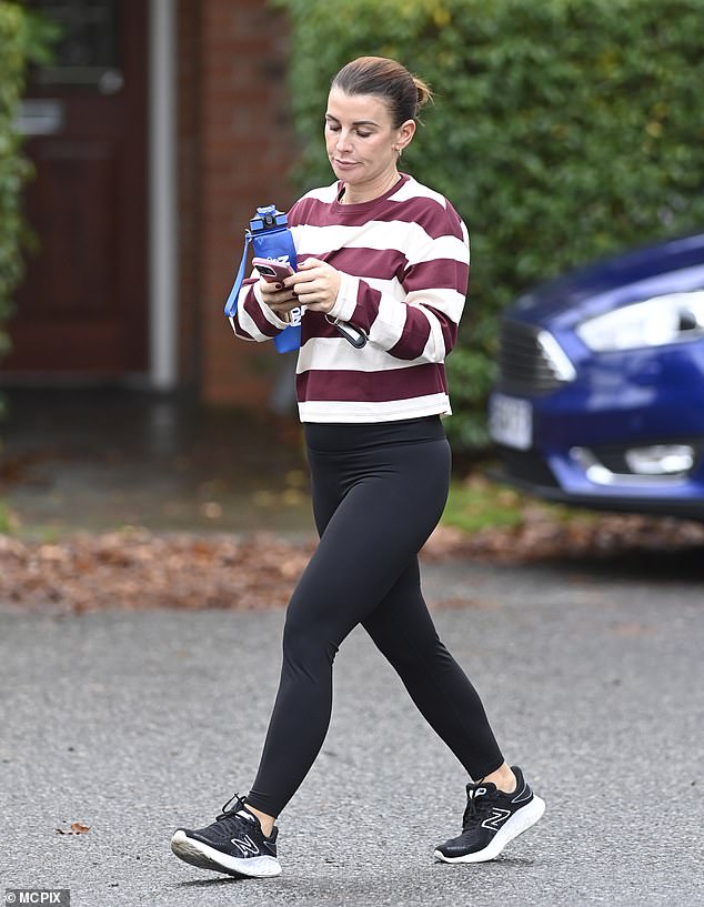 The WAG opted for tight black leggings and a white and burgundy striped sweatshirt