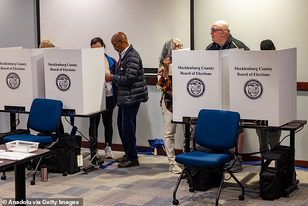 A record 2.8 million people in North Carolina (above) voted early — with tens of thousands of those votes coming from the storm-ravaged West.