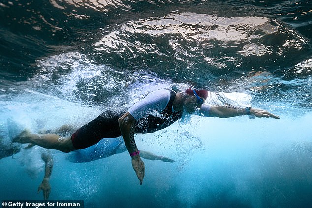 Tobias Hallebach of Germany competes in the swimming portion of the 2024 VinFast IRONMAN World Championship on October 26, 2024 in Kailua Kona, Hawaii