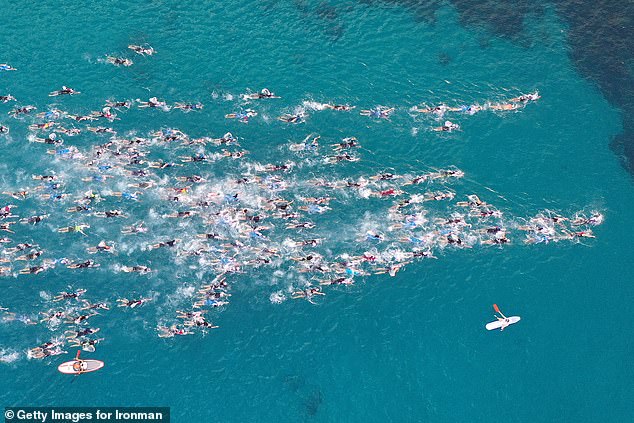 An aerial view as athletes compete in the swimming portion during the VinFast IRONMAN race