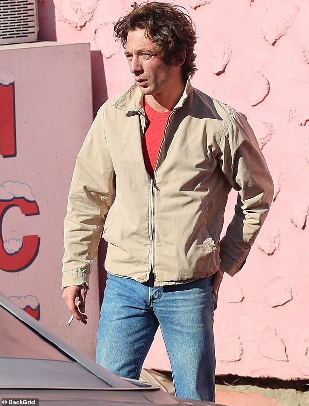 He was dressed in a costume that matched the 1980s setting of the film, including a khaki jacket, faded jeans, black leather low boots and a large leather bag.