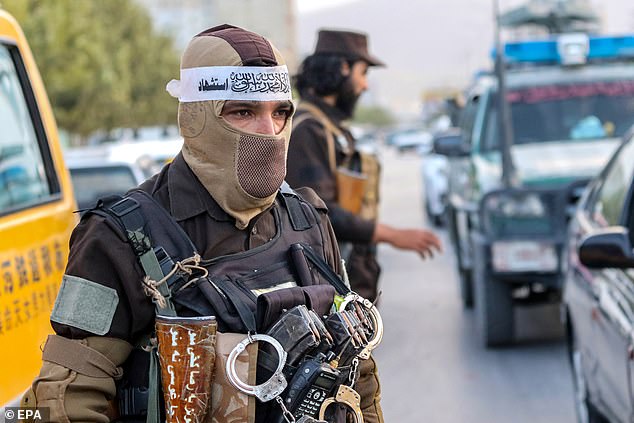 Taliban security officials stand guard as they check people and vehicles at a checkpoint in Kabul, Afghanistan, September 13, 2024