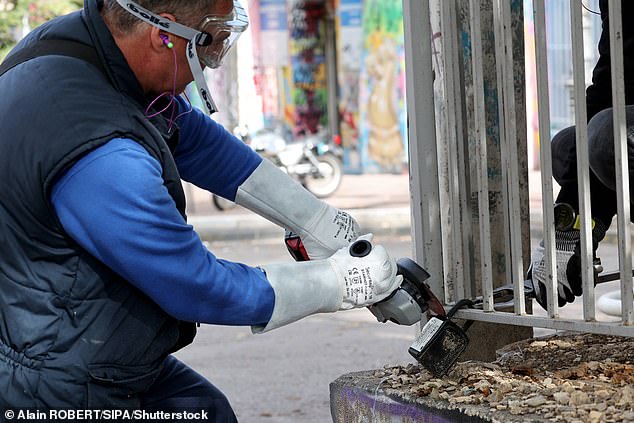 On October 28, a worker is seen cutting a key box from a railing in Marseille