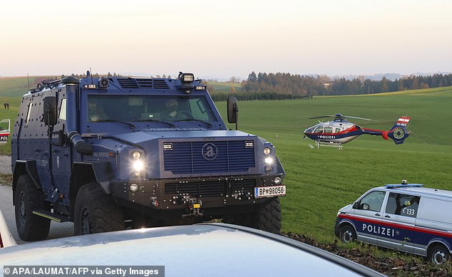 Police officers patrol near Rohrbach, Upper Austria, on October 28, 2024, during a manhunt for a gunman suspected of killing a local mayor and another person