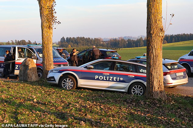 Police officers patrol near Rohrbach, Upper Austria, on October 28, 2024, during a manhunt for a gunman suspected of killing a local mayor and another person