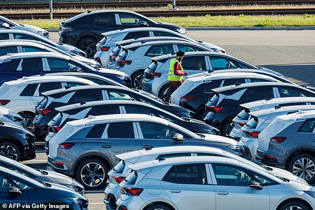 Volkswagen is being forced to close three of its factories and cut jobs, partly due to a slower-than-expected transition to electric vehicles. In the photo, employees load and unload Volkswagen cars on the site of the factory in Zwickau, East Germany on October 28, 2024