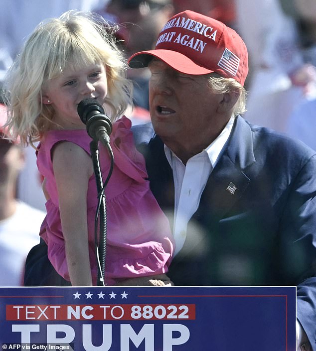 “He's running around the golf course drinking Diet Coke, probably on the phone with a world leader and she's in his arms,” Eric says of his father's relationship with his daughter Carolina. Donald Trump took the young girl on stage during his September 21 rally in Wilmington, North Carolina