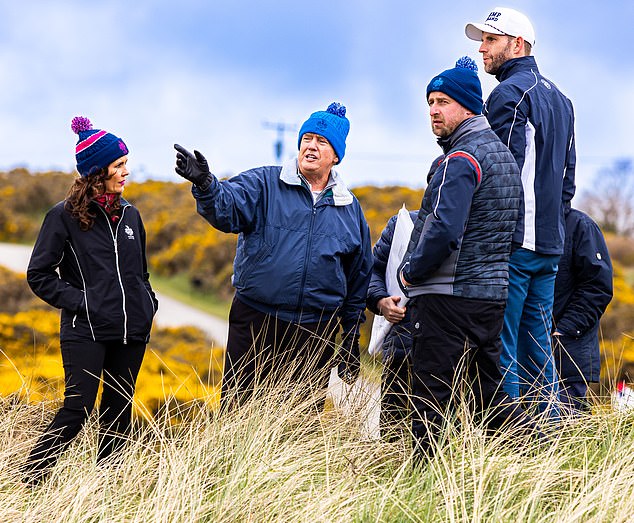 Donald (center) and Eric Trump (far right) speak with staff during work at the Trump International Golf Links in Aberdeenshire, Scotland. The business role allows Eric to 'disconnect' from politics and 'hide in the background' – an opportunity he cherishes, he says