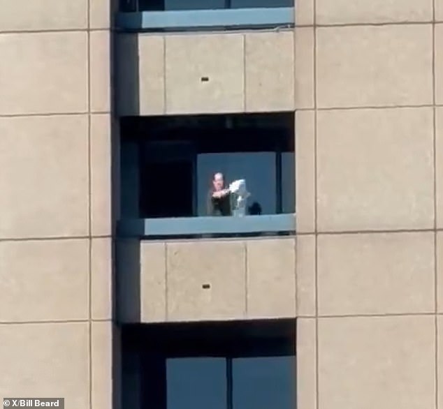 This is the moment a masked man threw items off the balcony of the Four Seasons Hotel in Atlanta on Tuesday afternoon before opening fire