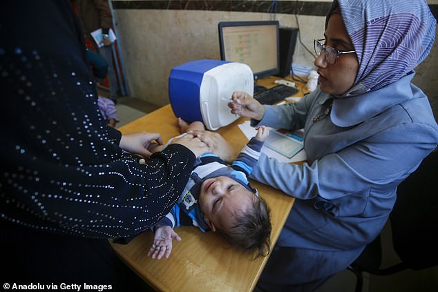 A baby being treated at the UN agency centre. British government figures have joined international condemnation of Israel after the Knesset voted to ban UNRWA from operating in Gaza