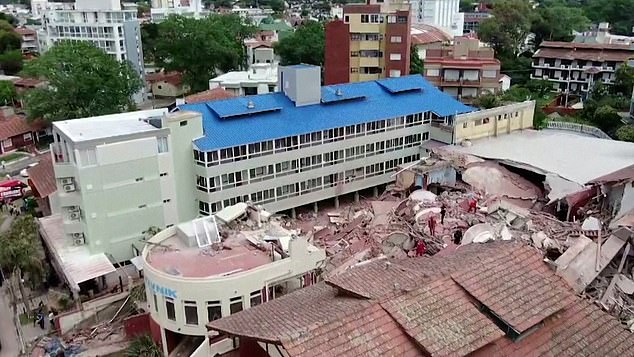 Rescue teams began removing the rubble by hand as they waited for a crane and some engineers to assess the area