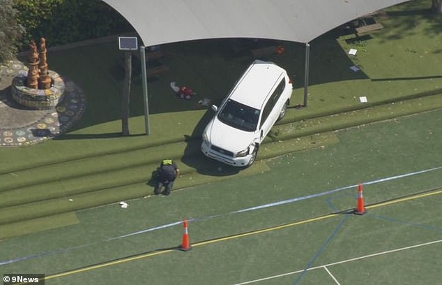 The Toyota SUV is seen with a damaged front bumper after crashing through the school gate