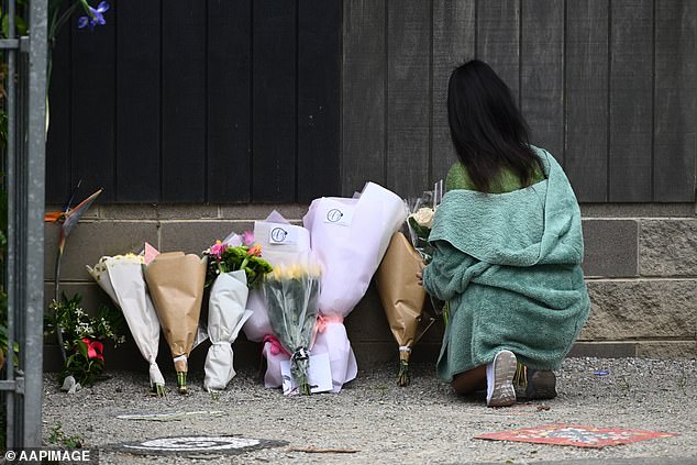 Teachers and students left bouquets of flowers at the school on Wednesday morning