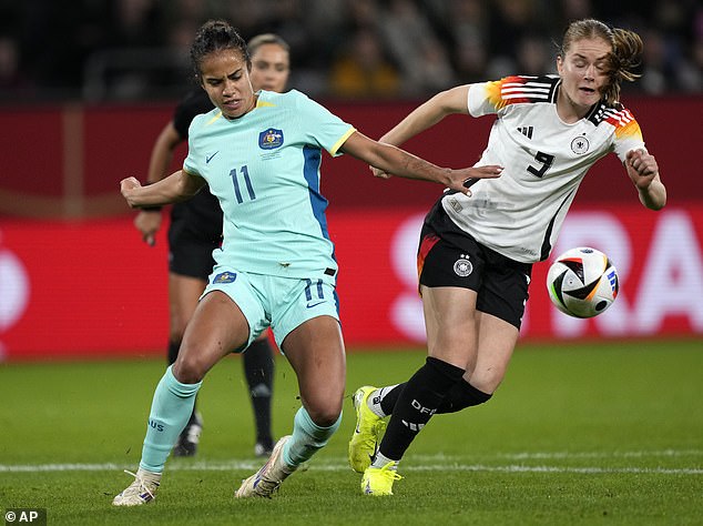 Fowler is pictured in action against Germany on Monday, with Cleary cheering her on from the stands along with some of her teammates