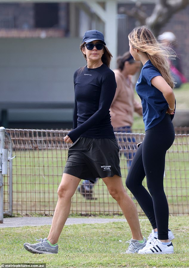 She pulled a cap low over her face as she spoke happily to her daughter