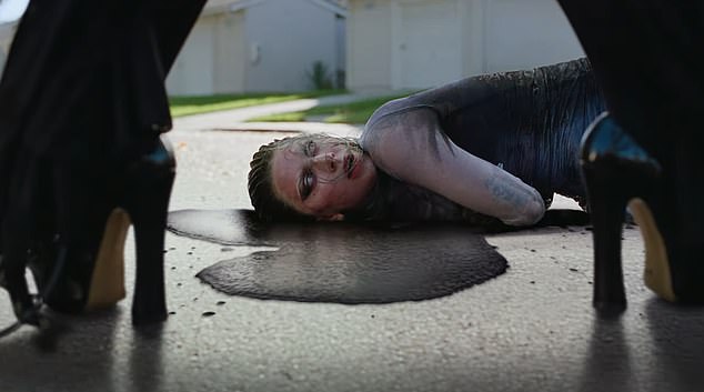 The creepy, leather-clad character is then seen vomiting black liquid next to another Lady Gaga lying on the top of her head