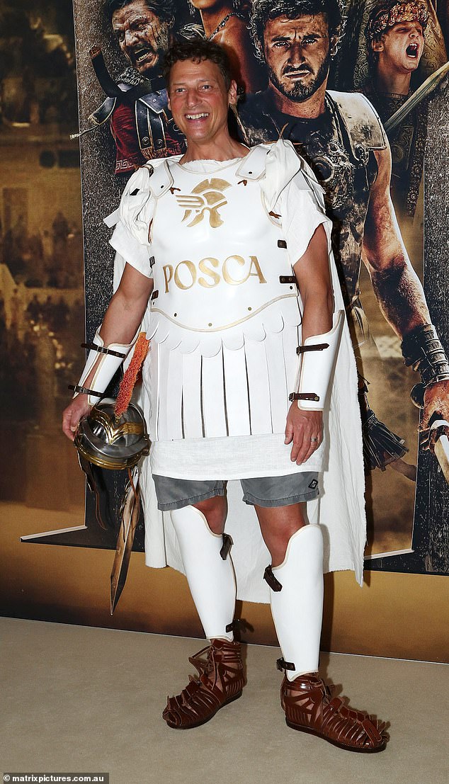 Merrick Watts, 50, (pictured) stuck with the theme and arrived at the premiere in a white Gladiator costume