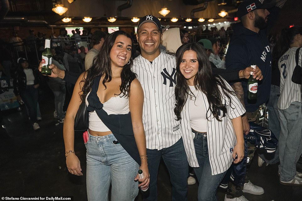 Three Yankees fans enjoy a postgame beer at Billy's, a sports bar next to the stadium in the Bronx, New York