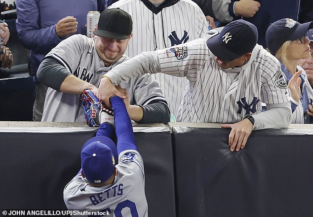 Two Yankees fans were later ejected after trying to grab a ball from Mookie Betts' glove