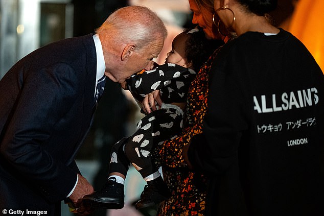 President Biden hugged the baby of his aide Ashley Williams (right). The baby was held by his longtime staffer and current deputy chief of staff Annie Tomasini.