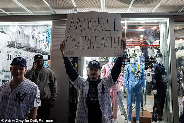 A Yankees fan stands up for himself with a homemade sign addressed to Mookie Betts