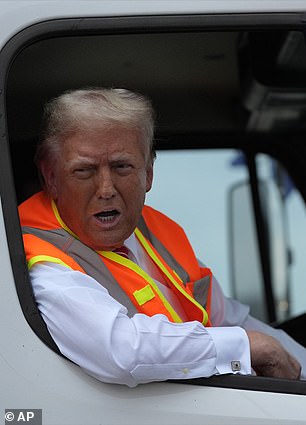 Former President Donald Trump talks to reporters while sitting in a garbage truck in Green Bay, Wisconsin, Wednesday, Oct. 30, 2024