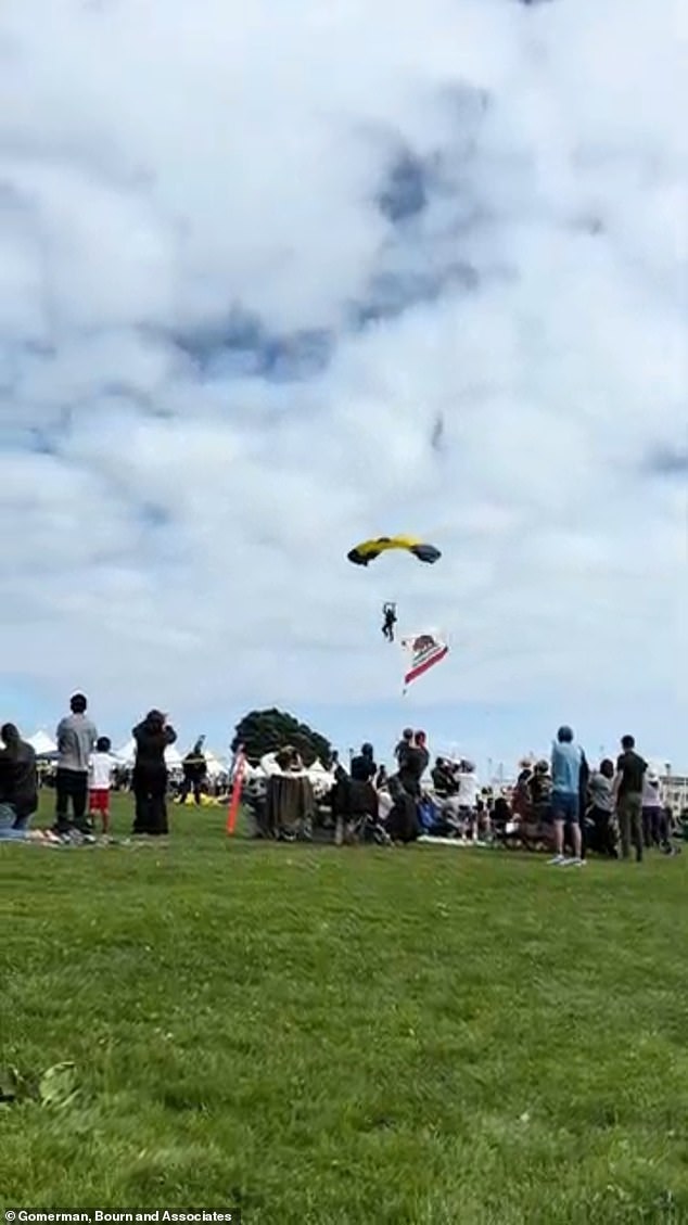 Another vantage point shows the parachutist about to land in the crowd