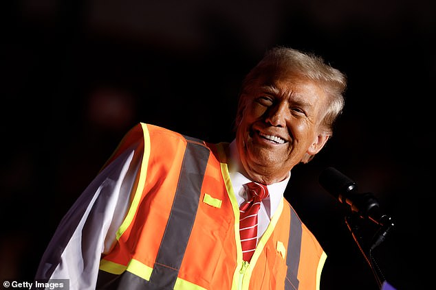 Trump wore a high-visibility vest for trash pickers at his rally in Wisconsin on Wednesday night as he tried to keep comments about his supporters being 