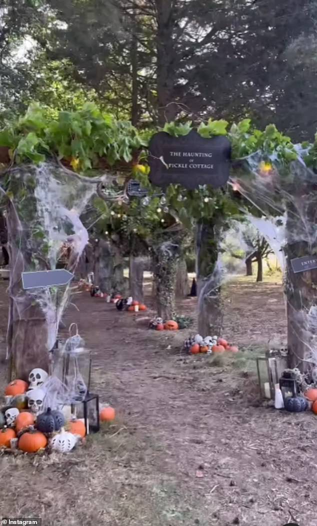 Complementing the aesthetic of their haunted house is an archway in the gardens covered in layers of spider webs, with mounds of pumpkins, skeletons and lanterns scattered along the way