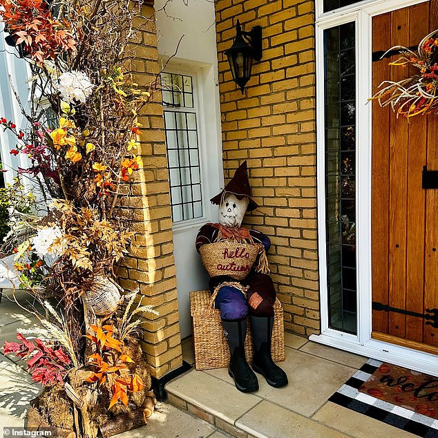 Although their decor is a bit more subdued this year given their sadness, this Queen of Clean still makes an impression with her homemade scarecrow adorning her doorway.